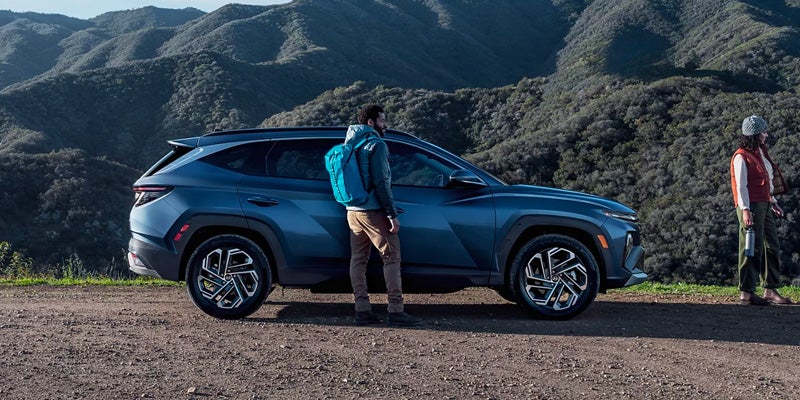 Couple Standing Near Hyundai Tucson Vehicle